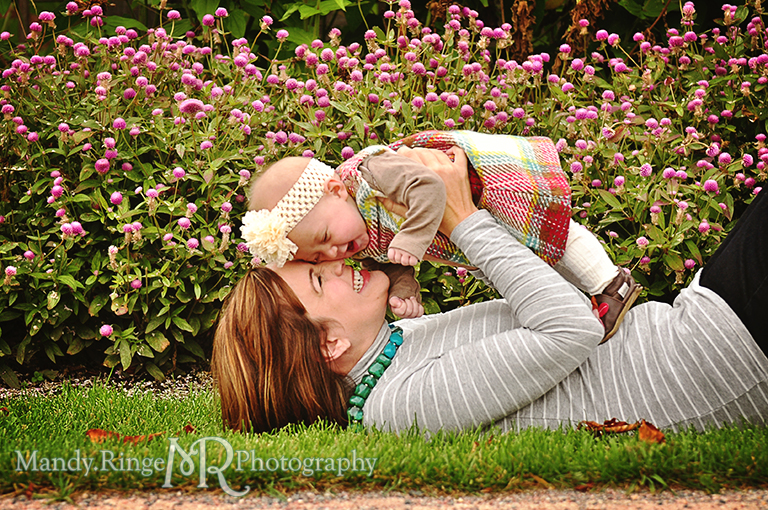 6 month old baby girl portraits // Mom laying down on the grass holding up the baby and snuggling her // Cantigny Gardens - Wheaton, IL // by Mandy Ringe Photography
