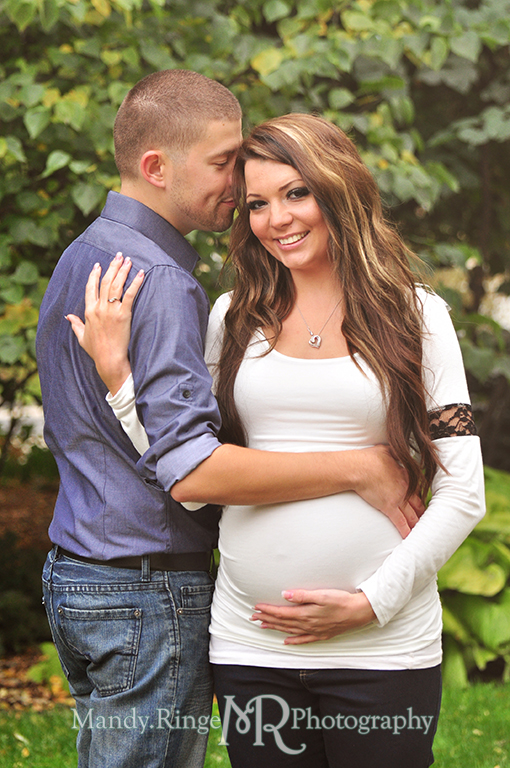 Man and pregnant woman holding her belly with the man kissing her head // Maternity portraits // Hurley Gardens - Wheaton, IL // by Mandy Ringe Photography