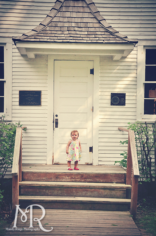 Baby girl standing in front of a one-room schoolhouse // Leroy Oaks // by Mandy Ringe Photography