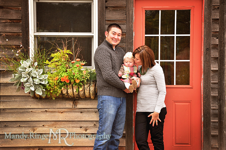 6 month old baby girl portraits // Posing with parents in front of a wooden building with an orange door // Cantigny Gardens - Wheaton, IL // by Mandy Ringe Photography