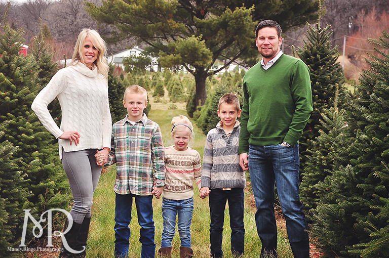 Family Christmas Portrait // Christmas Tree Farm // simple Christmas photo idea, standing in a row between pine trees // by Mandy Ringe Photography