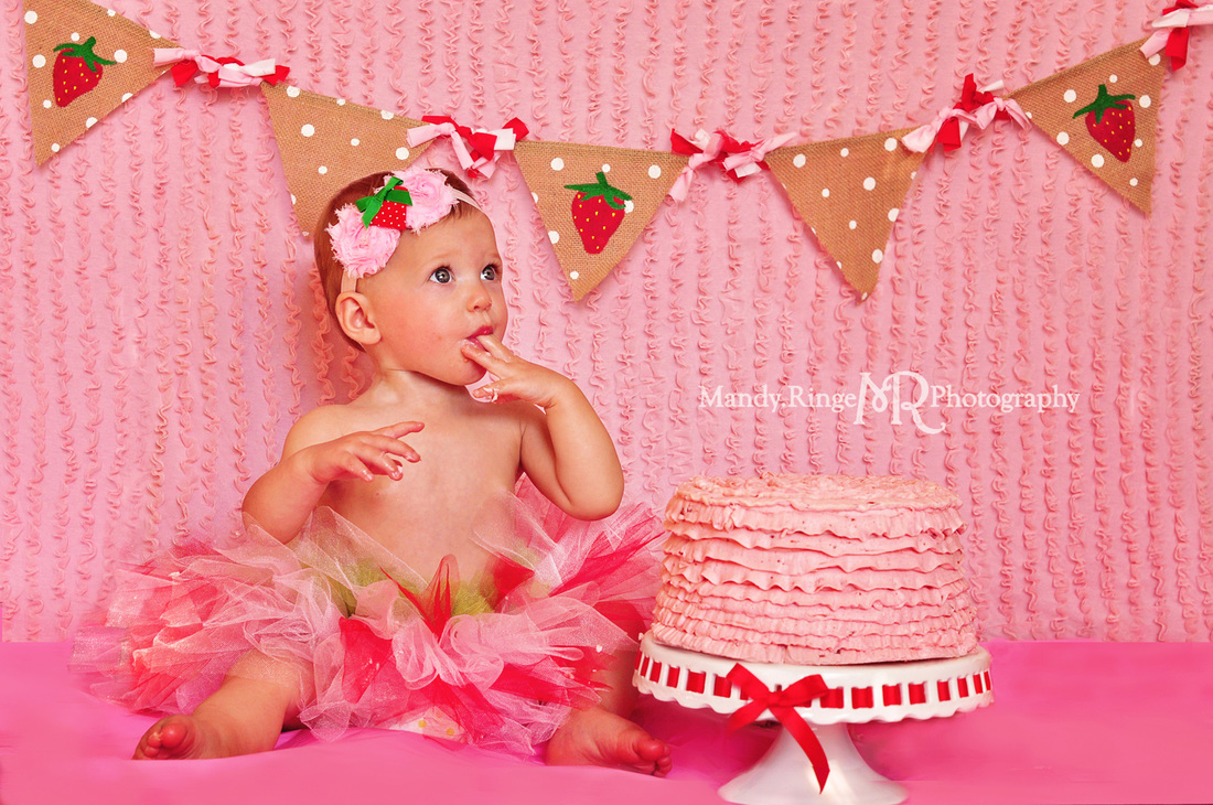 Girl first birthday portraits // Strawberry themed, cake smash, pink ruffle backdrop, pennant banner, tutu // by Mandy Ringe Photography