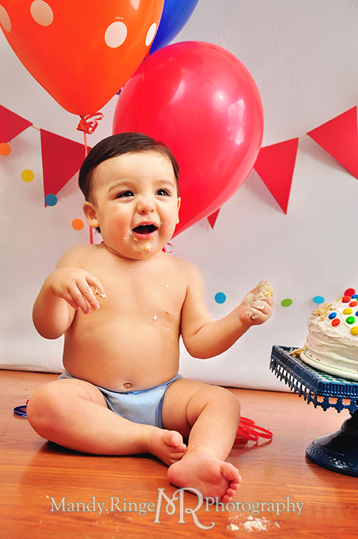 Boy's first birthday Elmo themed photo shoot // Smash cake session // Red pennant banners, multicolor dot garland, Elmo doll, balloons, cake with M&Ms // by Mandy Ringe Photography