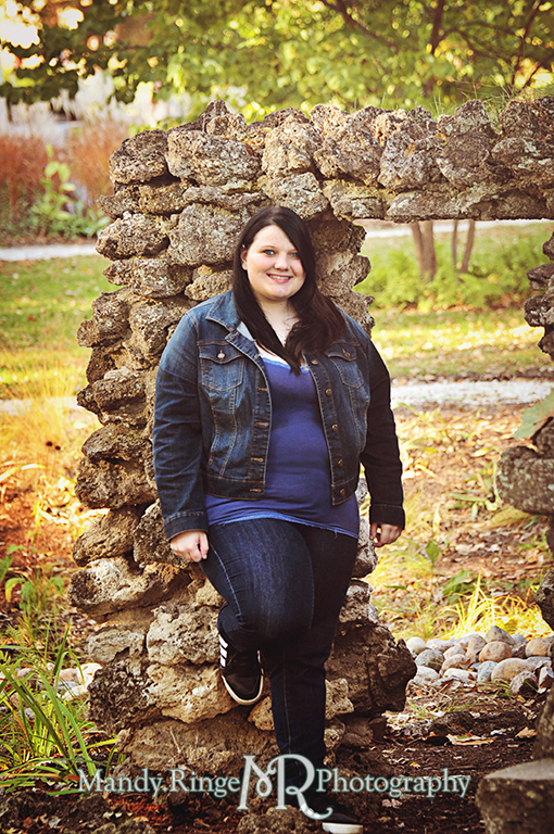 Teen girl leaning against a rock structure // Senior Photos // Fabyan Forest Preserve - Batavia, IL // by Mandy Ringe Photography