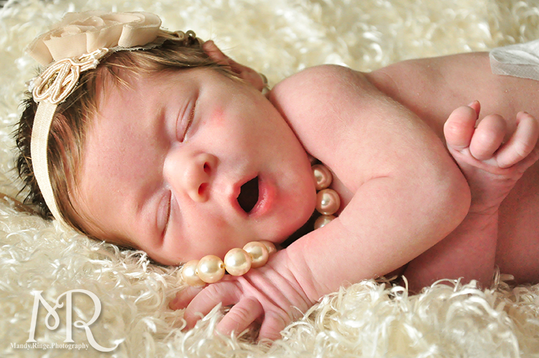 Newborn portrait with pearls and ivory flower headband // by Mandy Ringe Photography