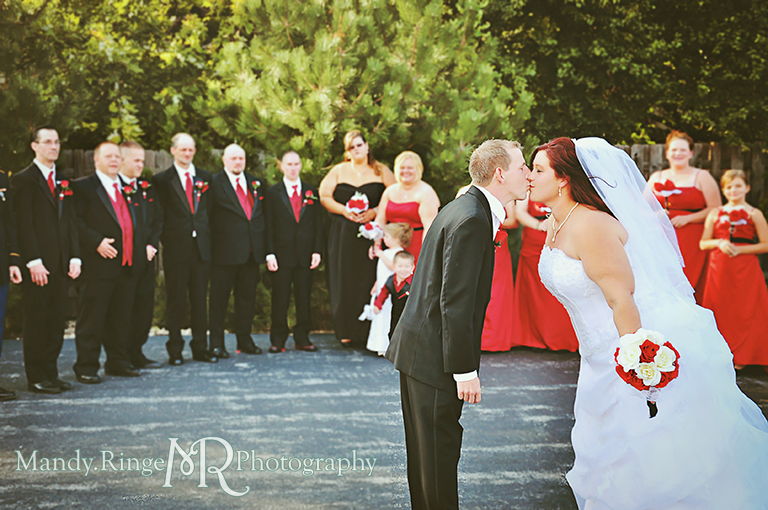 Bride and groom kissing in front of the wedding party - black, white and red wedding // Wedding Photography // Lincoln Inn Banquets - Batavia, IL // by Mandy Ringe Photography 
