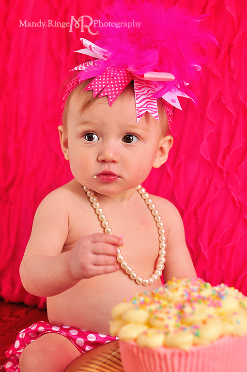 Baby girl's first birthday portraits // Smash cake session // Hot pink and white // Hot pink ruffle backdrop, pink polkadot diaper cover, white pearls // by Mandy Ringe Photography