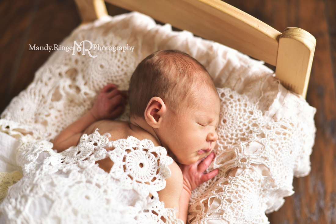 Newborn girl portraits // Dark wood backdrop, floordrop, small wooden bed, ruffle layer, vintage crochet doily layers // client's home - Geneva, IL // by Mandy Ringe Photography