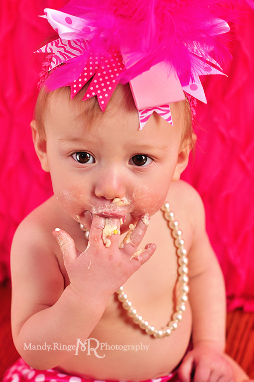 Baby girl's first birthday portraits // Smash cake session // Hot pink and white // Hot pink ruffle backdrop, pink polkadot diaper cover, white pearls // by Mandy Ringe Photography