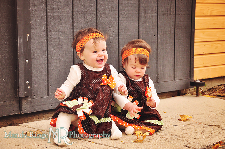 Fall portraits of 9 month old twins wearing Thanksgiving dresses // Sitting in front of a yellow barn // St. James Farm - Wheaton, IL // by Mandy Ringe Photography