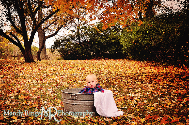 1 year old boy sitting in a wash tub with a blanket surrounded by fallen leaves // First birthday portraits // Leroy Oaks - St Charles, IL // by Mandy Ringe Photography