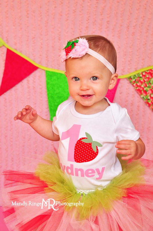 Girl first birthday portraits // Strawberry themed, pink ruffle backdrop, pennant banner, tutu // by Mandy Ringe Photography