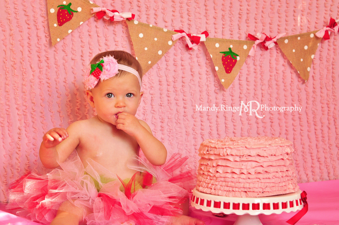 Girl first birthday portraits // Strawberry themed, cake smash, pink ruffle backdrop, pennant banner, tutu // by Mandy Ringe Photography