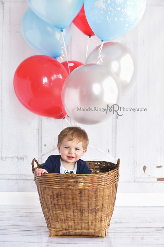 Boy's first birthday portraits // baby in a basket with balloons, hot air balloon, red, blue, silver // Traveling studio session at client's home - South Elgin, IL // by Mandy Ringe Photography