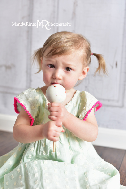 Toddler girl's second birthday portraits // Mint and hot pink, jawbreaker lollipop, sucker, two years old // client home - traveling studio // by Mandy Ringe Photography