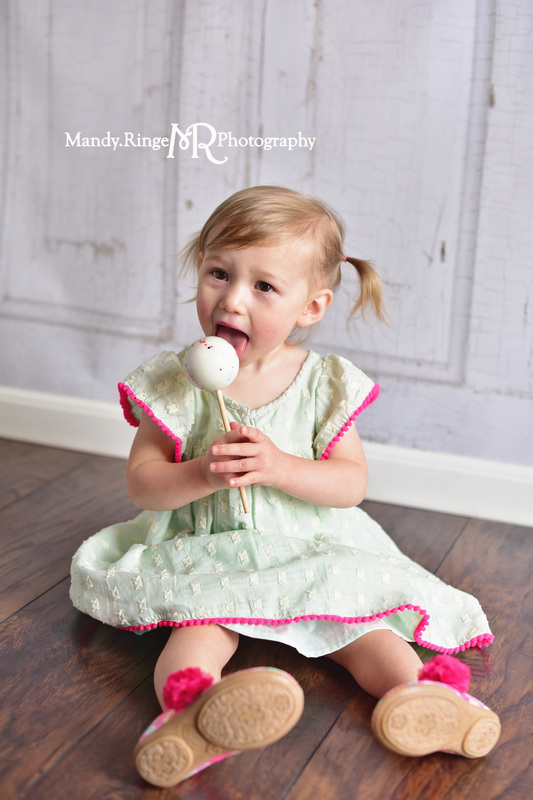 Toddler girl's second birthday portraits // Mint and hot pink, jawbreaker lollipop, sucker, two years old // client home - traveling studio // by Mandy Ringe Photography