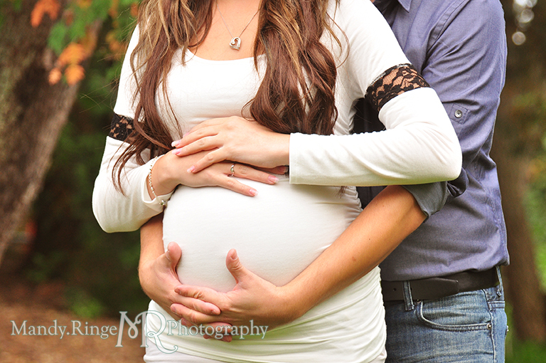 Woman with hands on top of belly, man standing behind her with hands under belly // Maternity portraits // Hurley Gardens - Wheaton, IL // by Mandy Ringe Photography