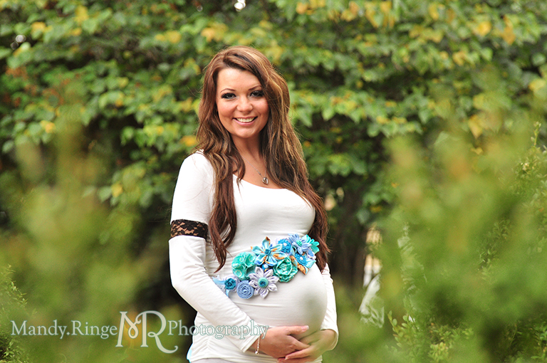 Pregnant woman holding her belly and wearing a handmade blue maternity sash // Maternity portraits // Hurley Gardens - Wheaton, IL // by Mandy Ringe Photography