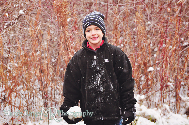 Outdoor winter photo of young boy holding a snowball // Rustic wooded setting // Ferson Creek Fen - St Charles, IL // by Mandy Ringe Photography