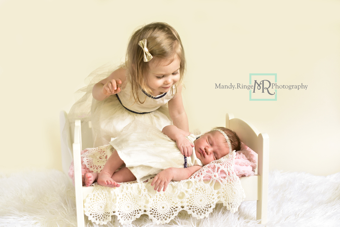 Newborn girl portraits // Sibling portraits, baby bed, vintage doily layer, white fur, matching dresses, ivory and navy // Client's home - St Charles, IL // Mandy Ringe Photography