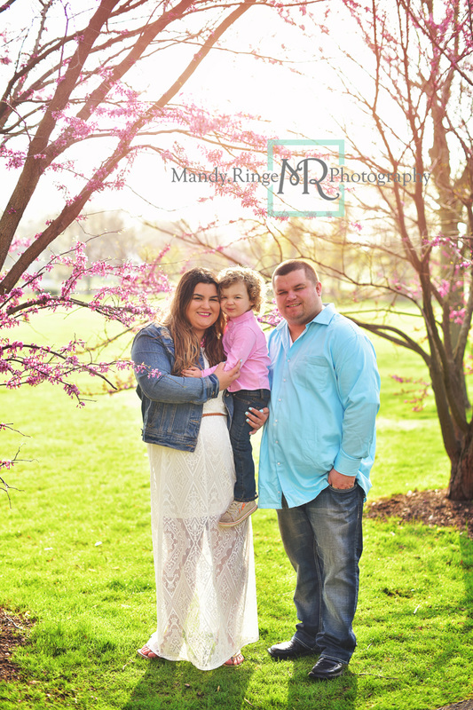 Spring family portraits // red bud tree, pink and blue, outdoors, family of three, flowers // Mount St. Mary Park - St Charles, IL // by Mandy Ringe Photography